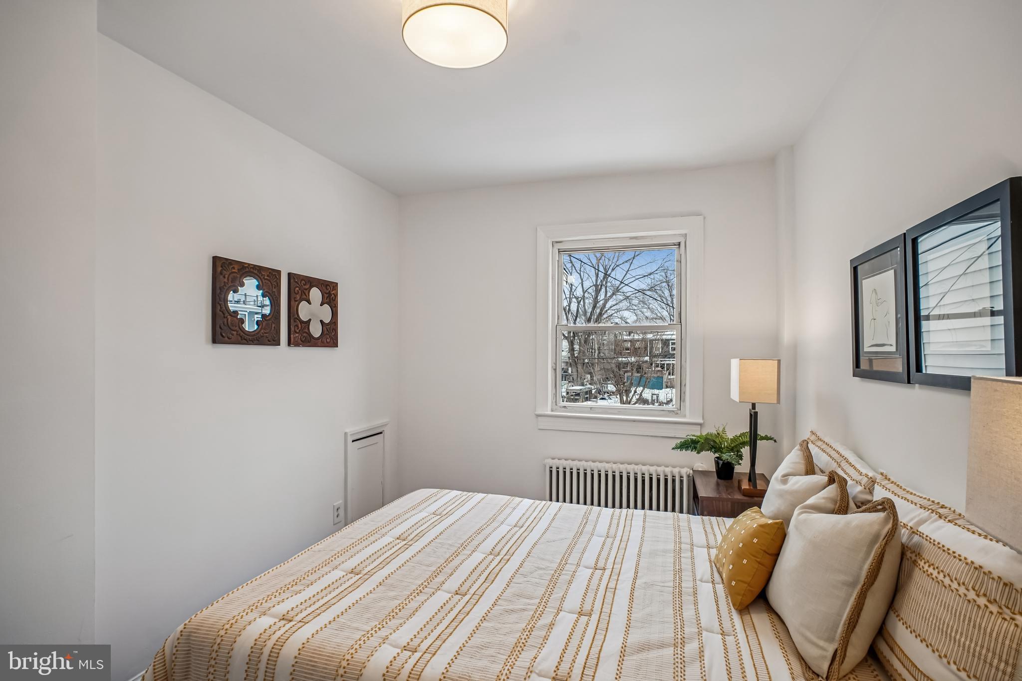 423 20th Street Northeast Washington, DC 20002 - Photo 31 of 35 a bedroom with a bed and wooden floor