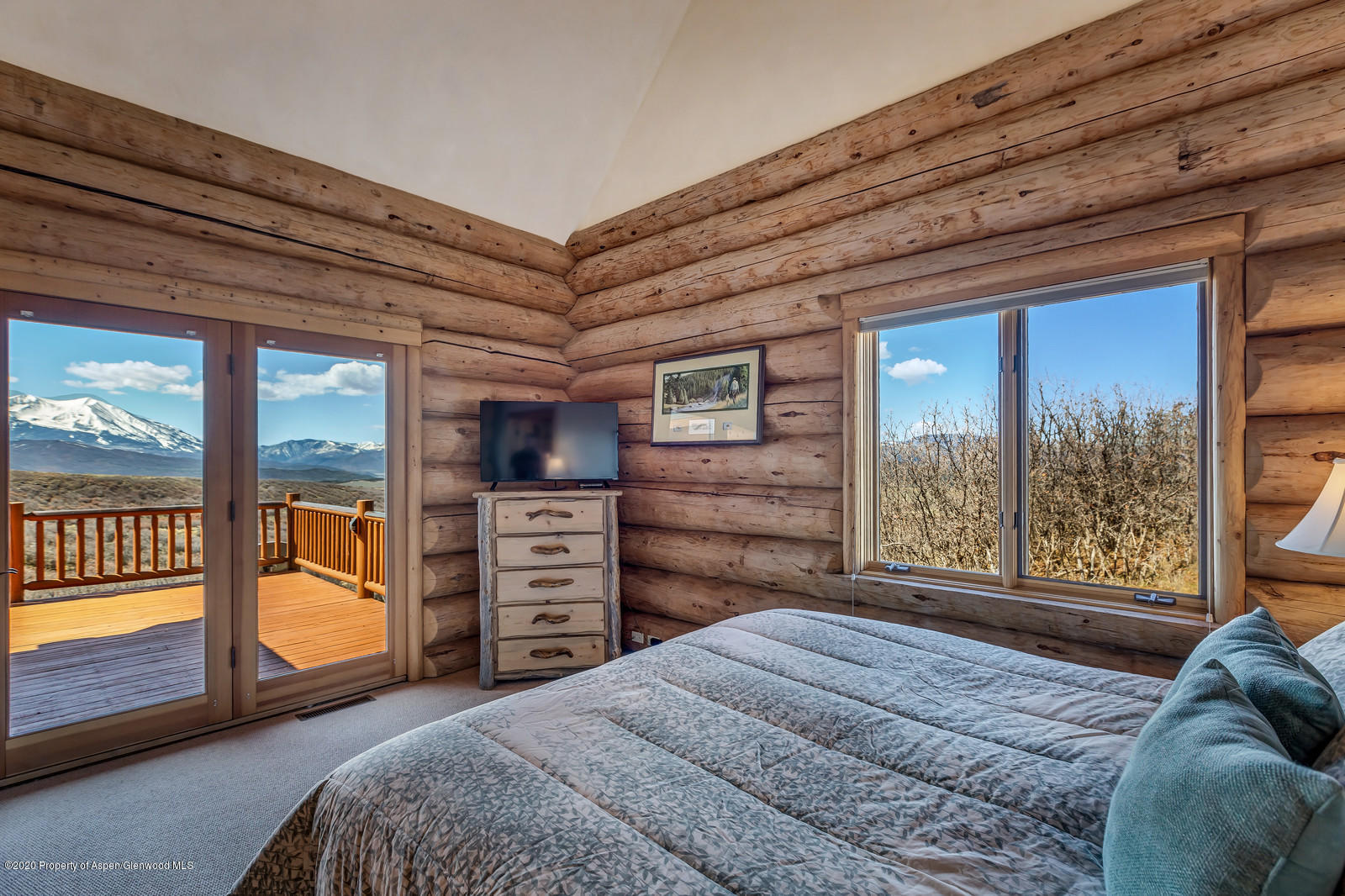 1121 Spring Park Road Carbondale, CO 81623 - Photo 14 of 41 a bedroom with a bed and large windows with the outer view