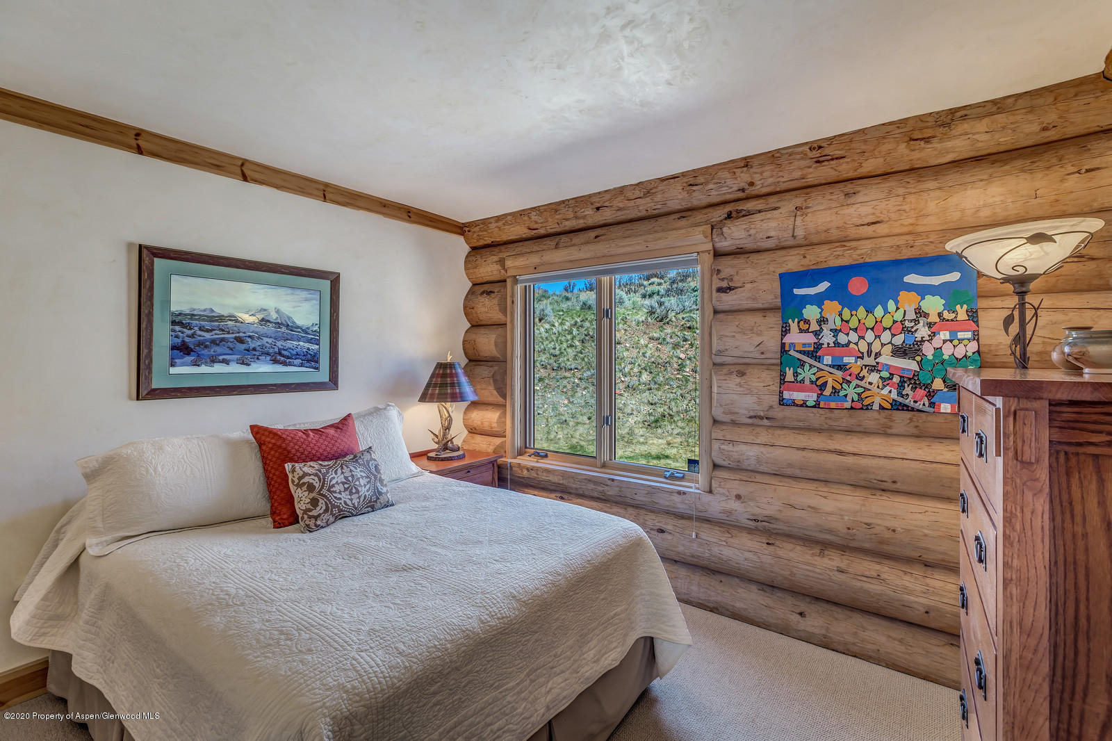 1121 Spring Park Road Carbondale, CO 81623 - Photo 23 of 41 a bedroom with a bed and a painting on the wall