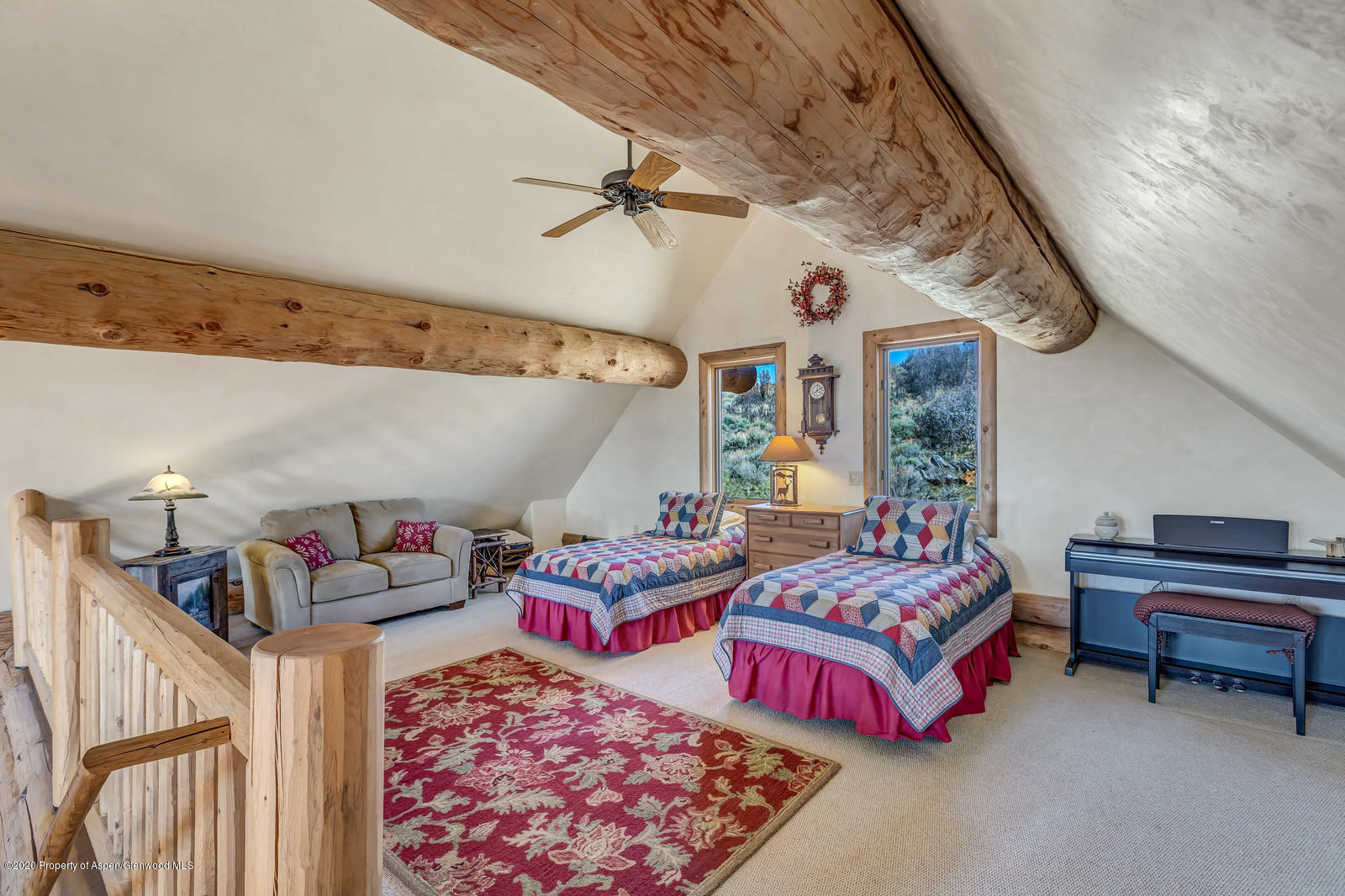 1121 Spring Park Road Carbondale, CO 81623 - Photo 25 of 41 a bedroom with furniture and a chandelier