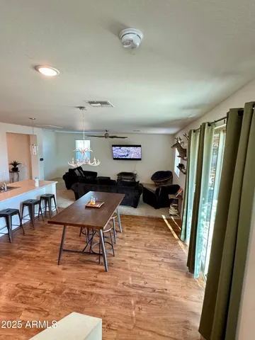 a living room with furniture a rug and a large window