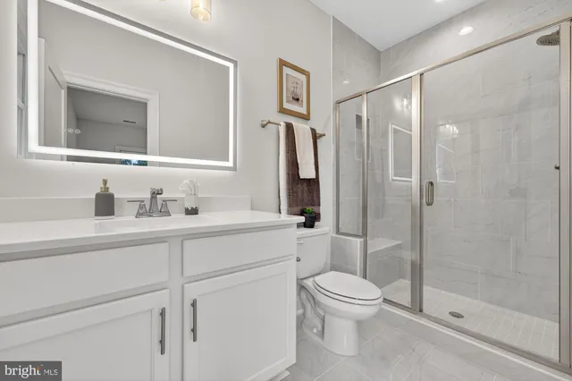 a spacious bathroom with a tub sink shower and mirror