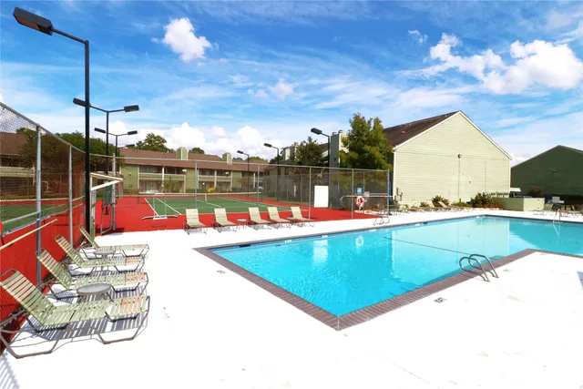 a view of a swimming pool and lounge chairs