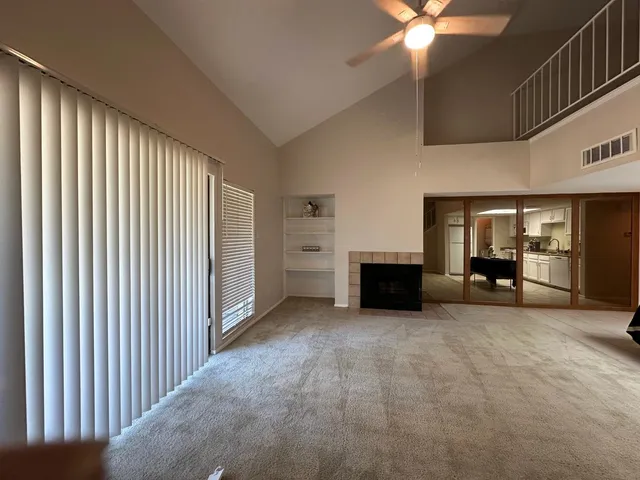 a view of an empty room with a fireplace