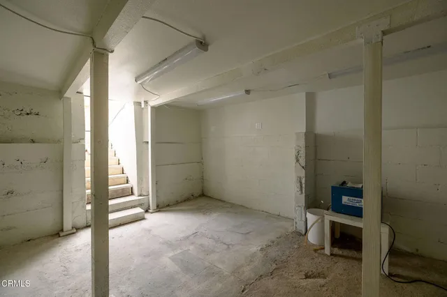 a view of a storage & utility room with two washing machine