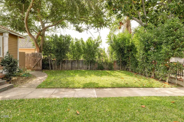 a view of a white house with a yard and microwave