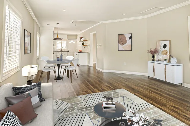 a living room with furniture and wooden floor