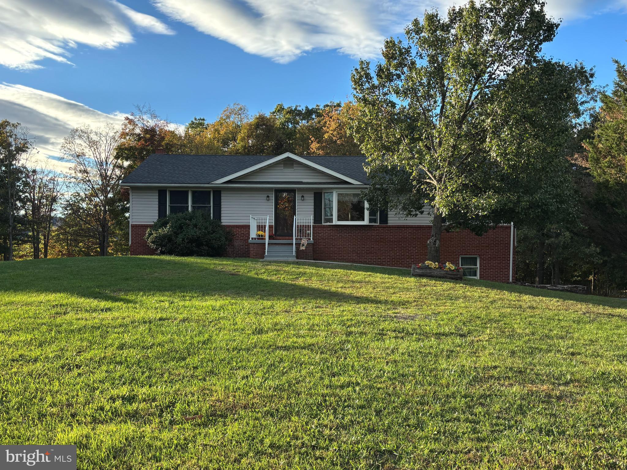 25 Nelson Lane Berkeley Springs, WV 25411 - Photo 1 of 27 a front view of a house with a yard