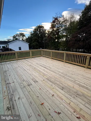 a view of balcony with wooden floor and fence