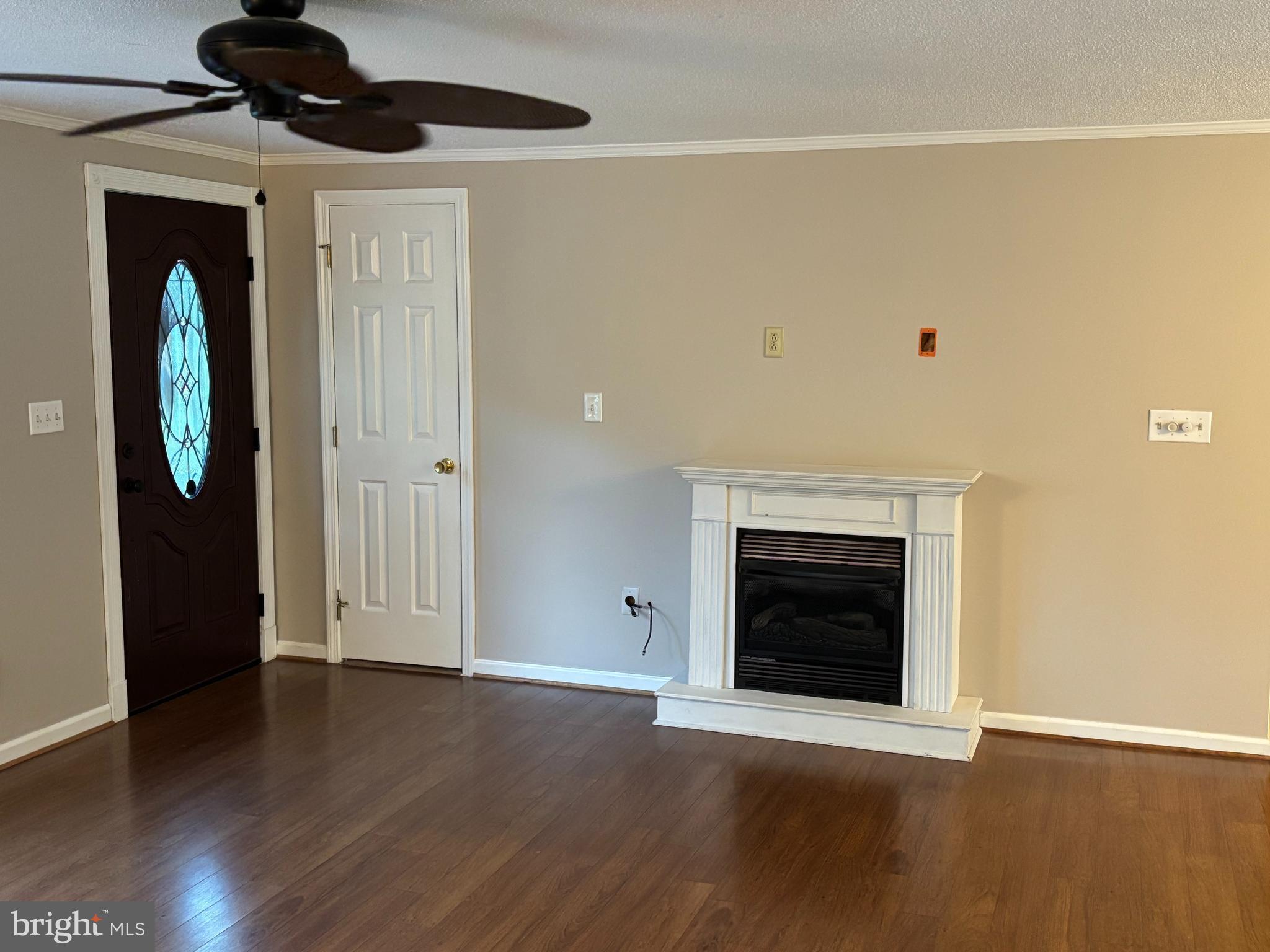 25 Nelson Lane Berkeley Springs, WV 25411 - Photo 6 of 27 a view of an empty room with wooden floor and a fireplace