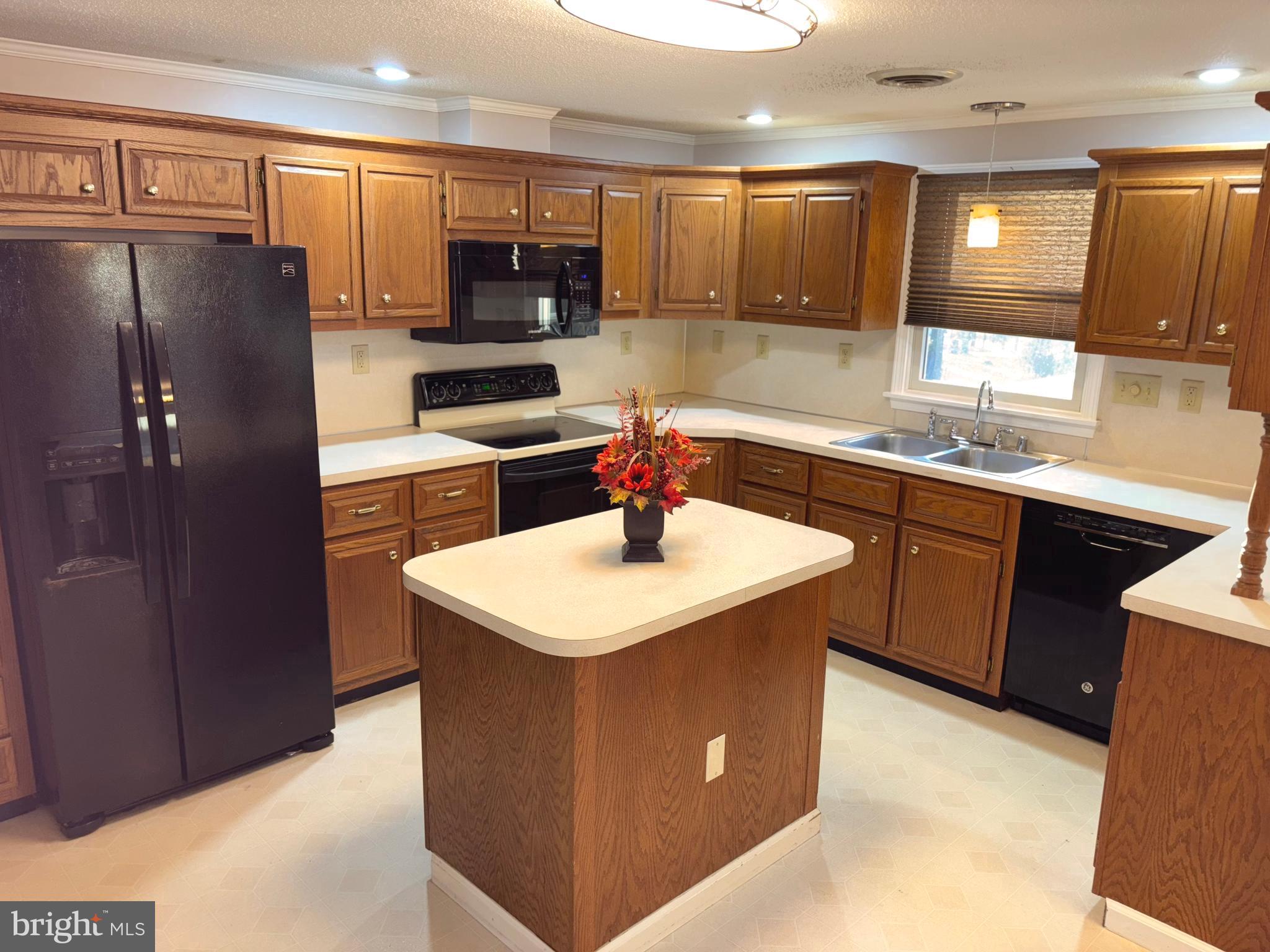 25 Nelson Lane Berkeley Springs, WV 25411 - Photo 9 of 27 a kitchen with stainless steel appliances a sink a stove a refrigerator a center island and a cabinets
