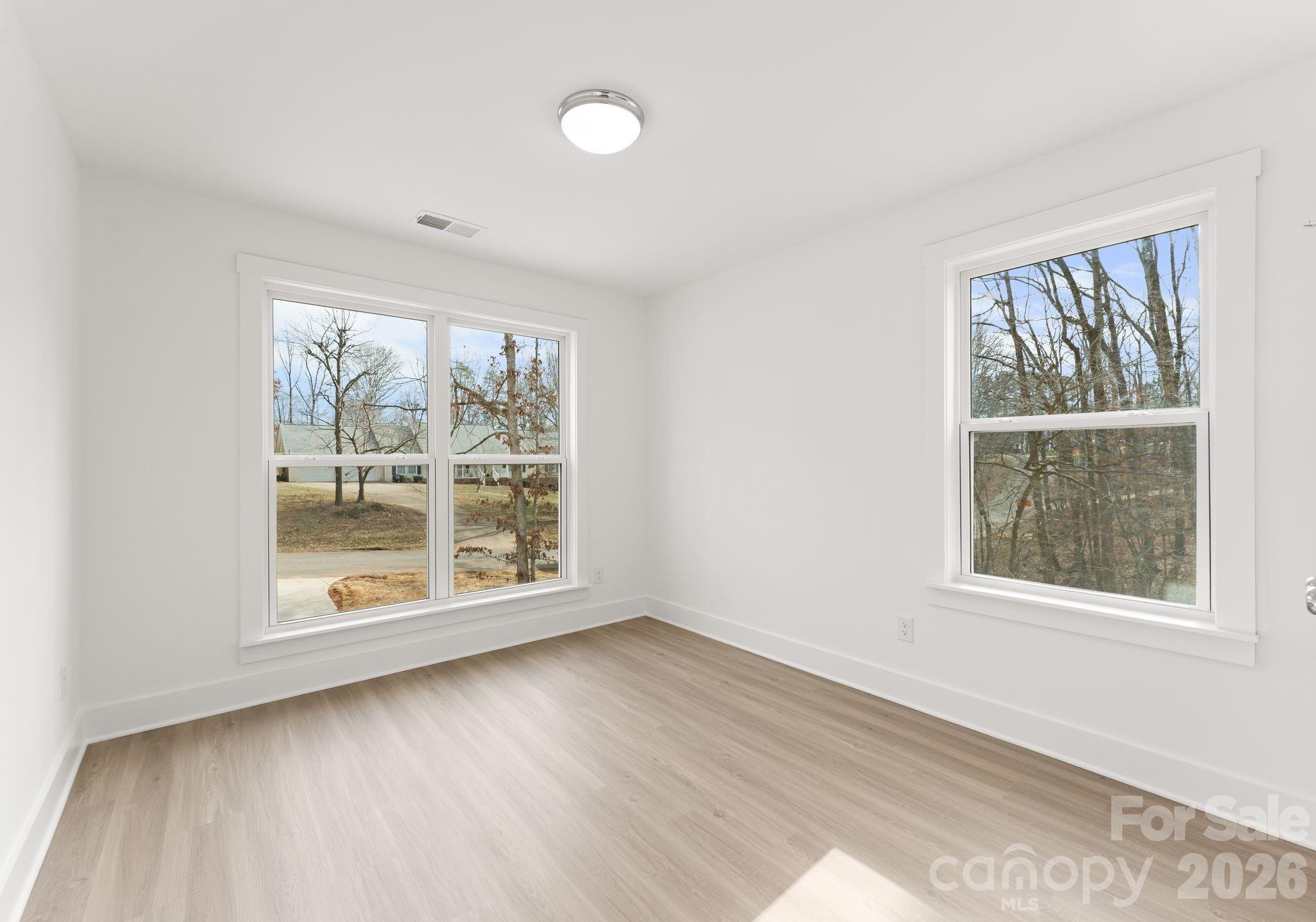 1906 Rucker Road Shelby, NC 28152 - Photo 18 of 21 an empty room with wooden floor and windows