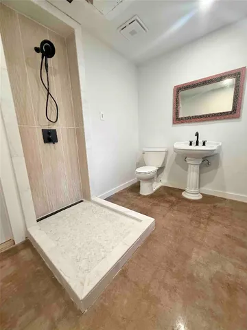 a view of a room with wooden floor and bathroom