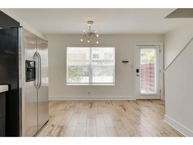 a kitchen with stainless steel appliances kitchen island granite countertop a refrigerator stove top oven and sink