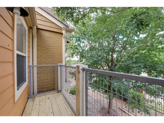 a balcony with wooden floor and outdoor space