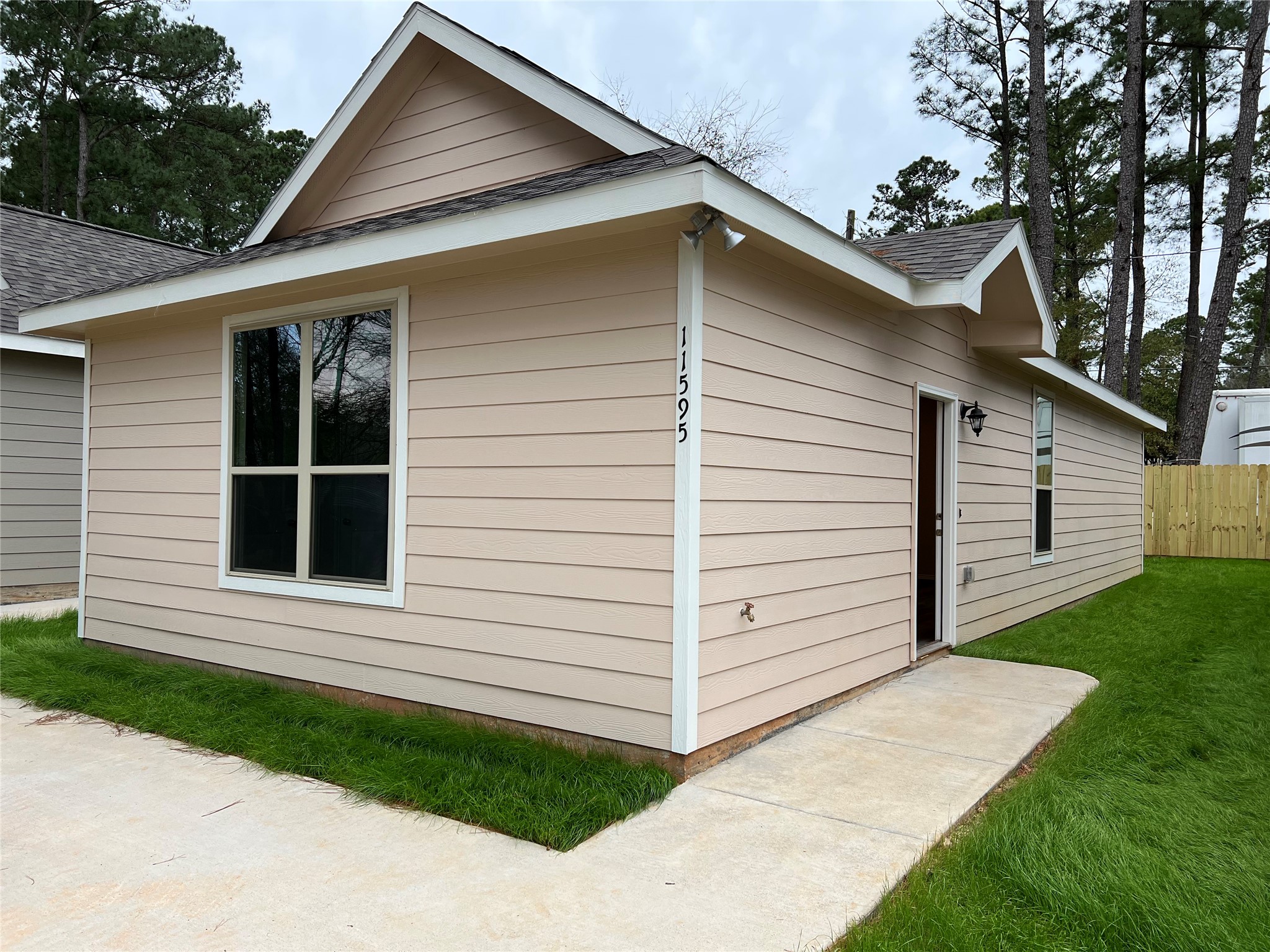 11595 Persimmon Street Willis, TX 77318 - Photo 1 of 14 a view of a house with a yard