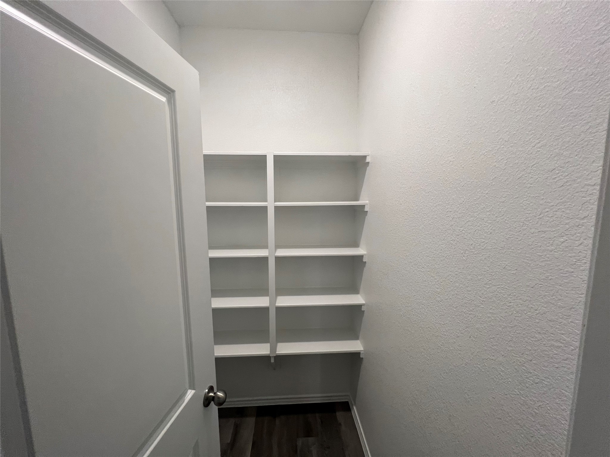 11595 Persimmon Street Willis, TX 77318 - Photo 11 of 14 a view of walk in closet with empty racks