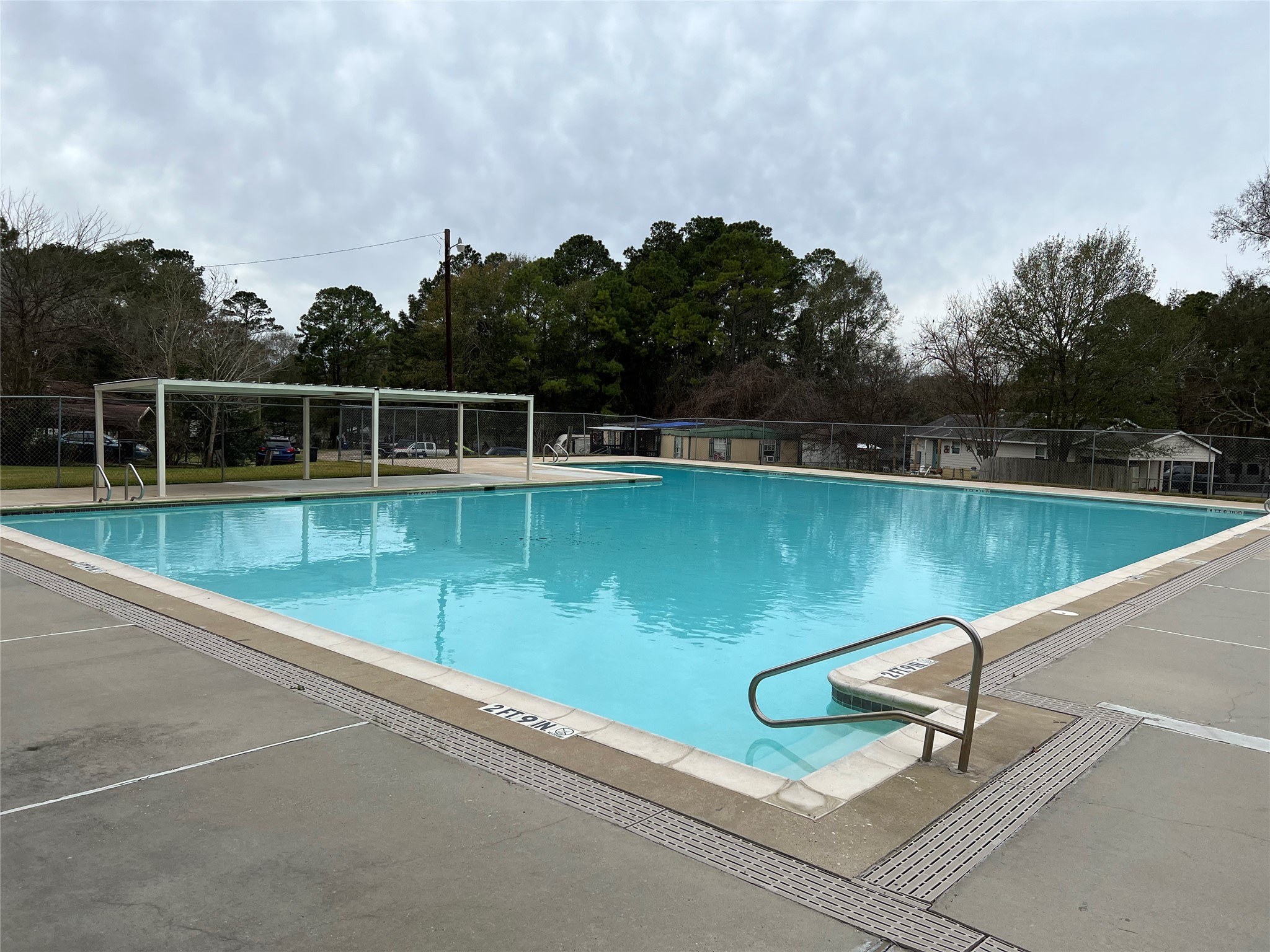11595 Persimmon Street Willis, TX 77318 - Photo 13 of 14 a view of a lake with a floor to ceiling window and wooden fence