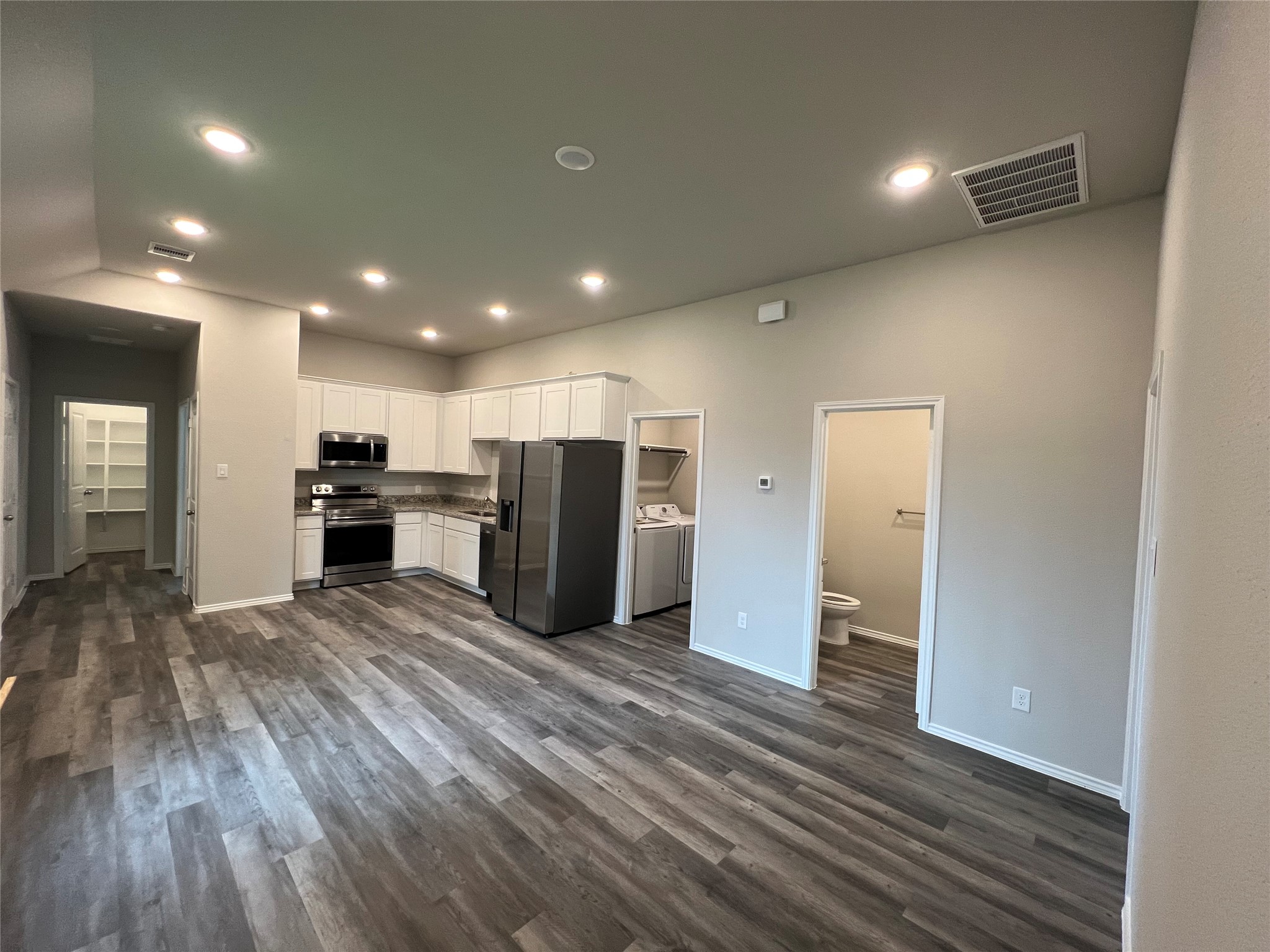 11595 Persimmon Street Willis, TX 77318 - Photo 5 of 14 a view of kitchen with refrigerator microwave and stove top oven