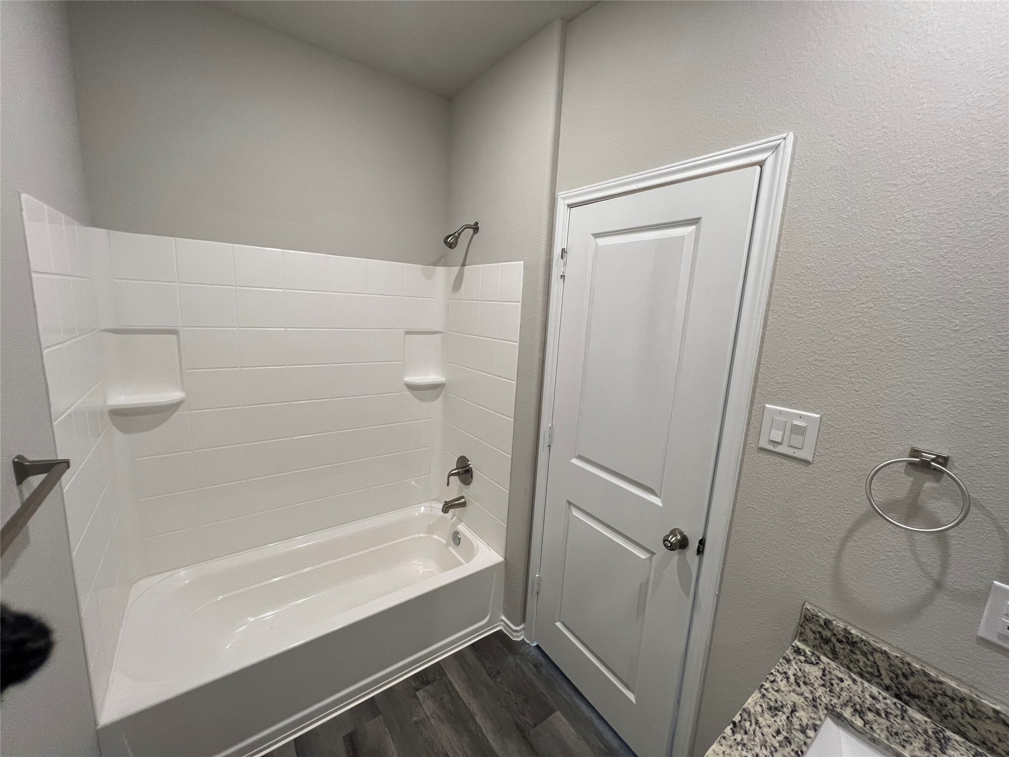 11595 Persimmon Street Willis, TX 77318 - Photo 7 of 14 a bathroom with a bathtub and a shower