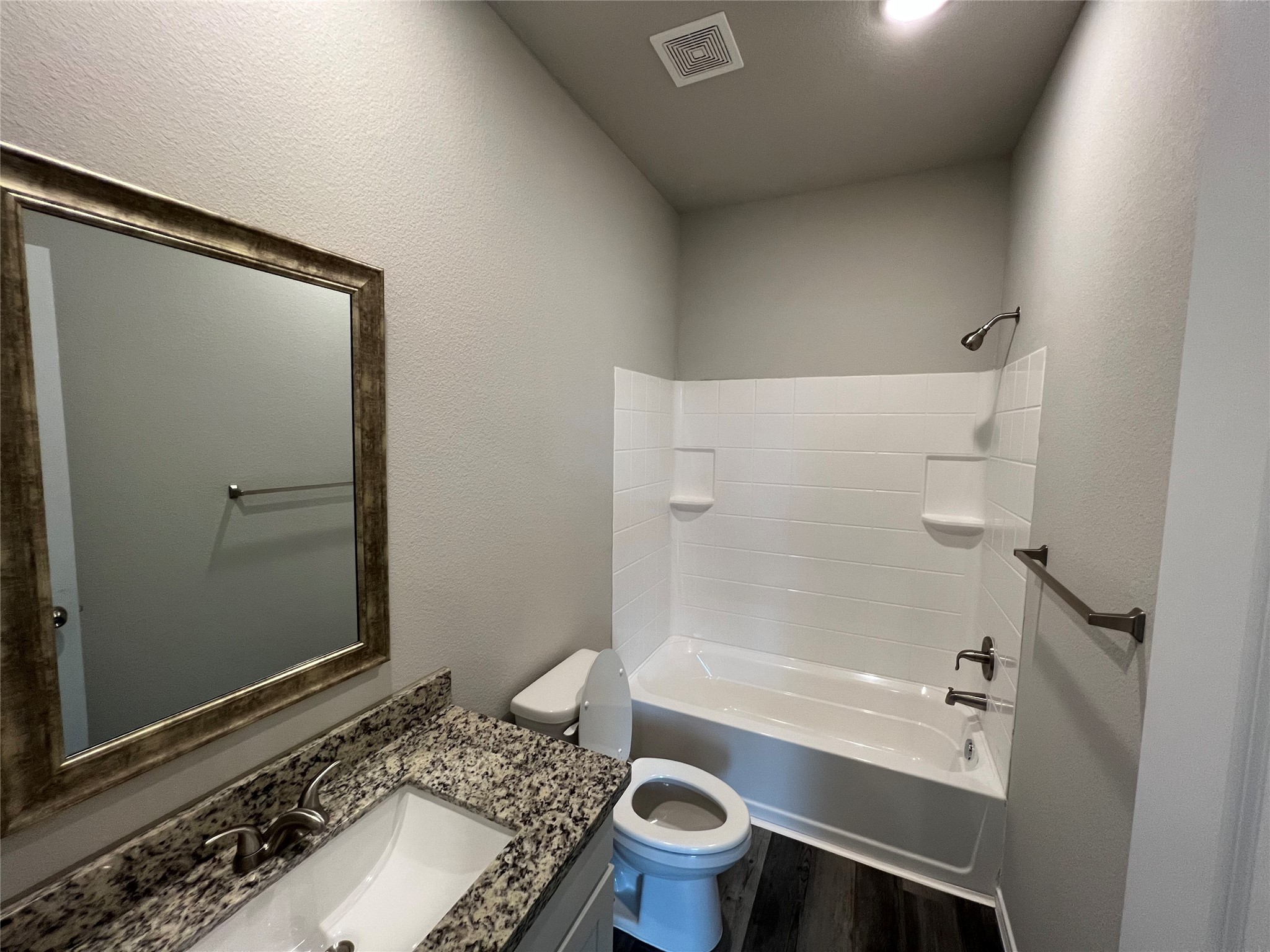 11595 Persimmon Street Willis, TX 77318 - Photo 9 of 14 a bathroom with a granite countertop sink toilet and shower