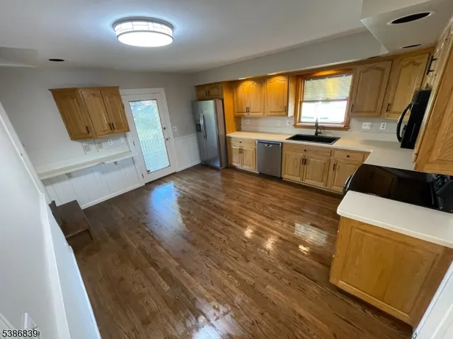 a kitchen with a sink a refrigerator and window