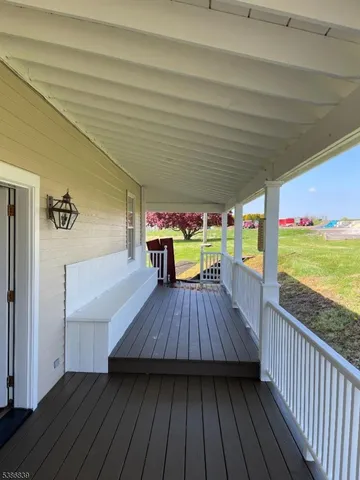 a view of deck with wooden floor and outdoor seating