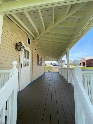 a view of a balcony with wooden floor