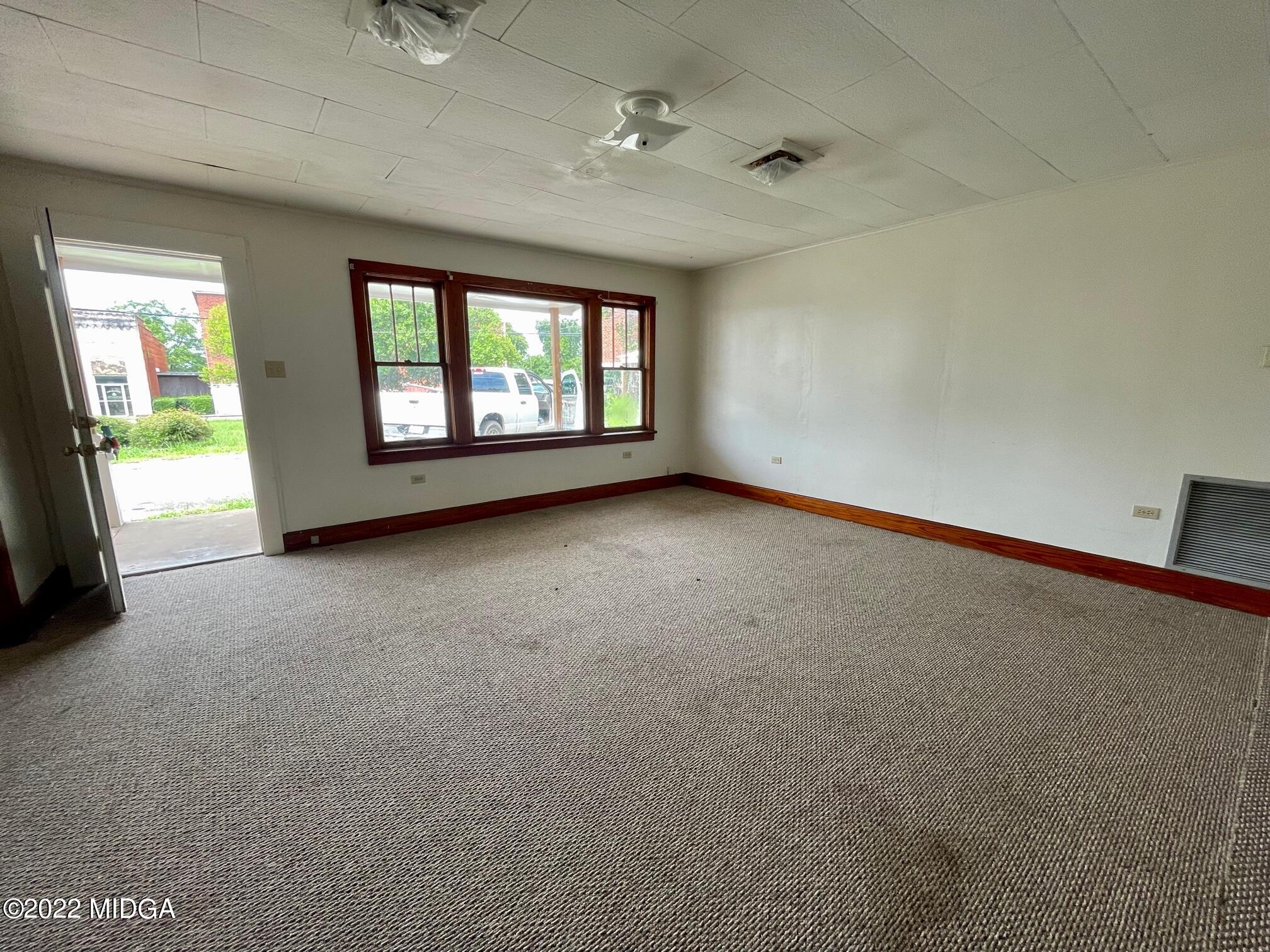 102 Asbell Street Irwinton, GA 31042 - Photo 4 of 8 an empty room with windows
