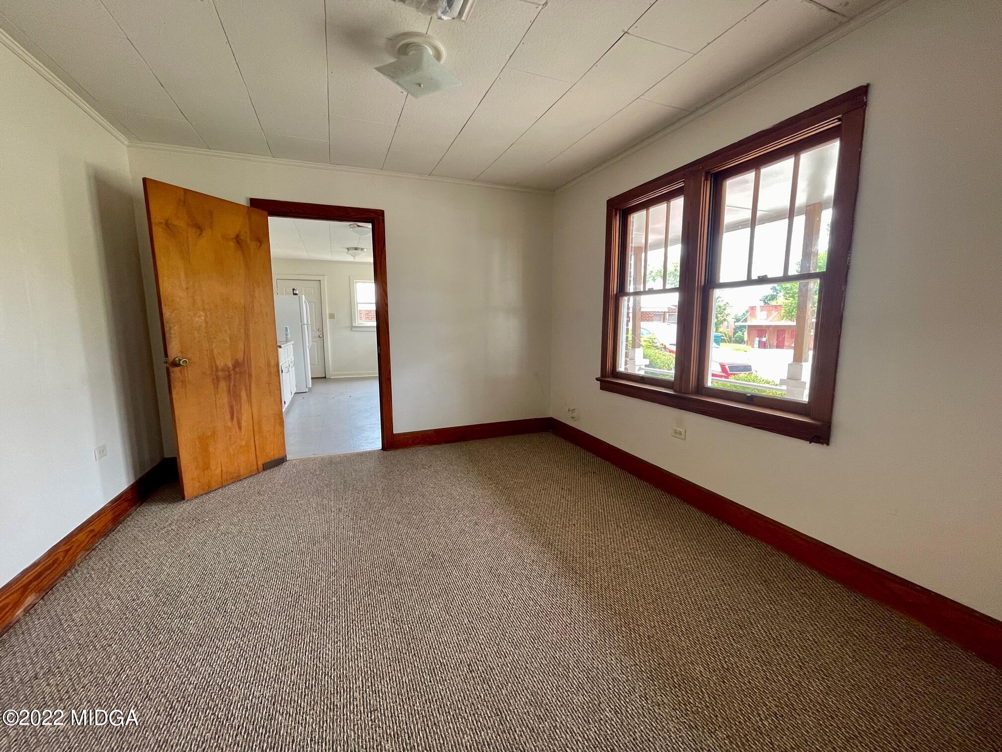 102 Asbell Street Irwinton, GA 31042 - Photo 6 of 8 an empty room with windows and closet