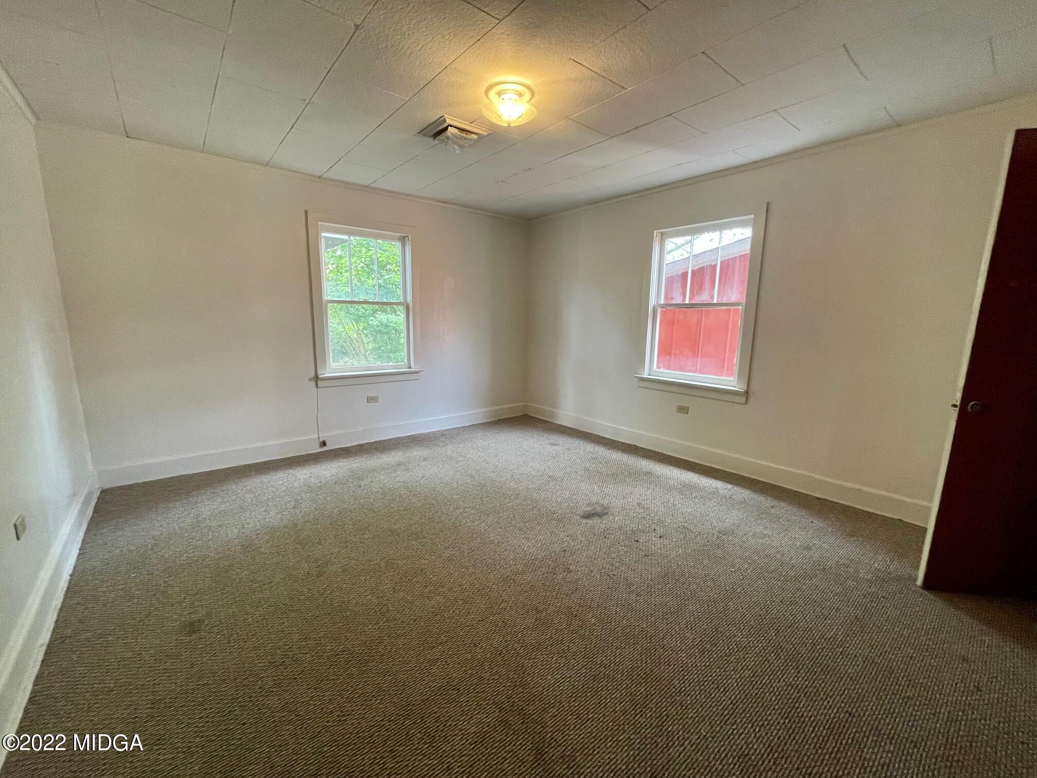 102 Asbell Street Irwinton, GA 31042 - Photo 8 of 8 an empty room with windows