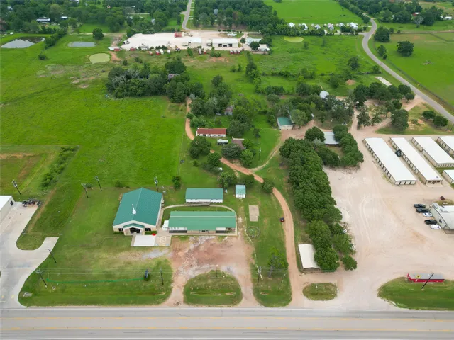 an aerial view of a house with a yard basket ball court and outdoor seating