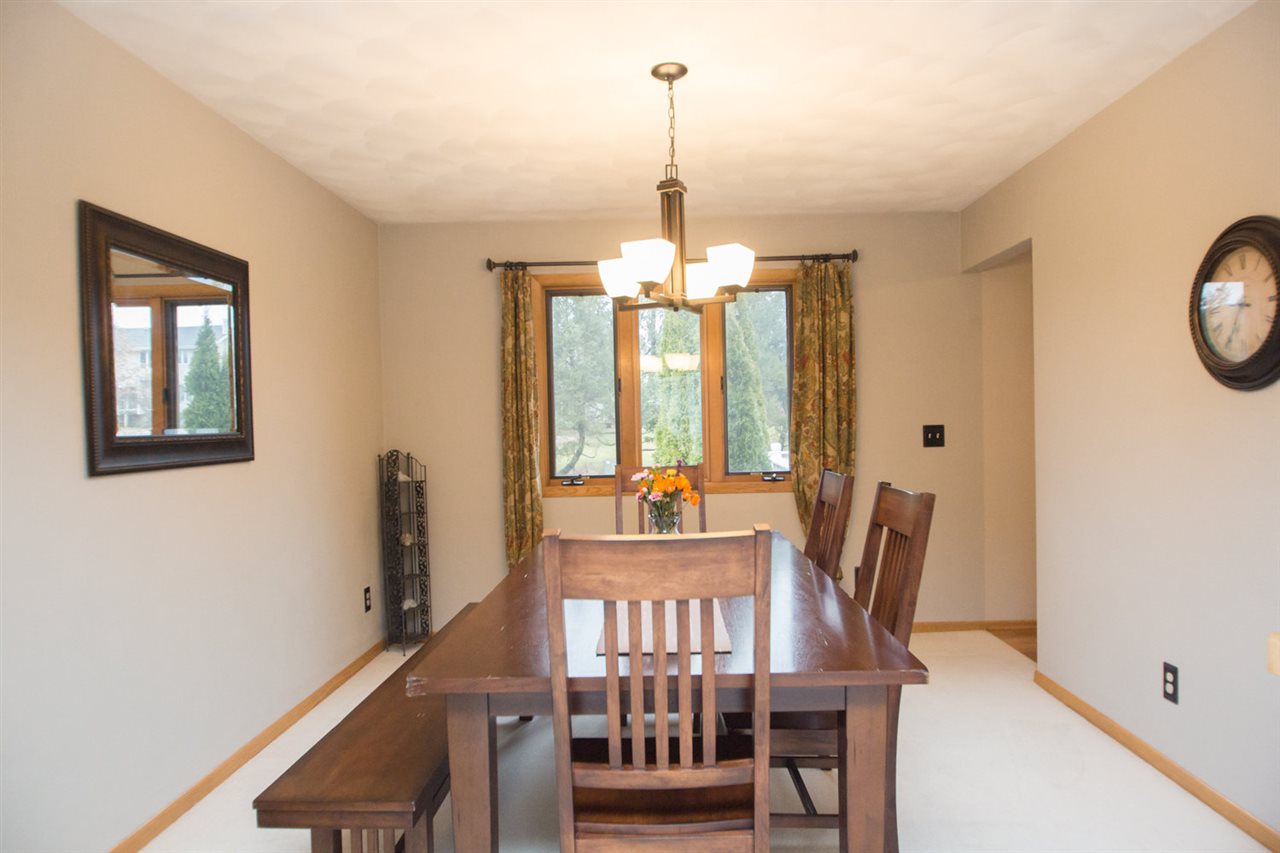 7068 Rye Ridge Trail Cherry Valley, IL 61016 - Photo 8 of 23 a view of a dining room with furniture window and wooden floor