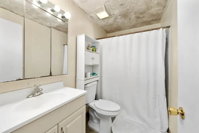 a bathroom with a sink toilet and shower