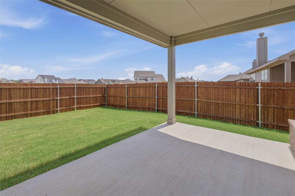 1217 Colca Drive Springtown, TX 76082 - Photo 20 of 25 Covered concrete patio opening to a fenced rear yard with a manicured lawn