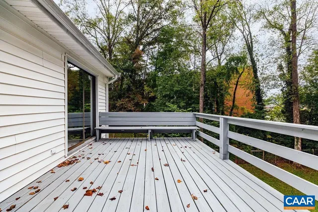 a view of backyard with deck and wooden floor