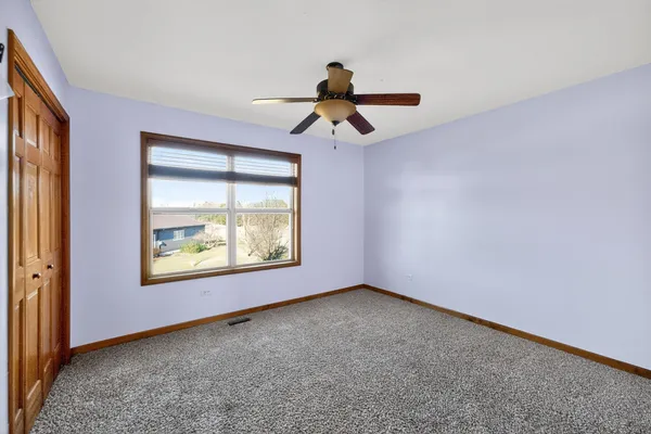 a view of room with window and ceiling fan
