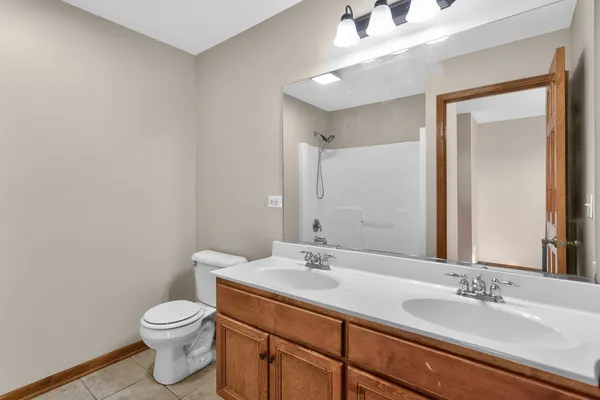 a bathroom with a granite countertop sink a toilet and a mirror