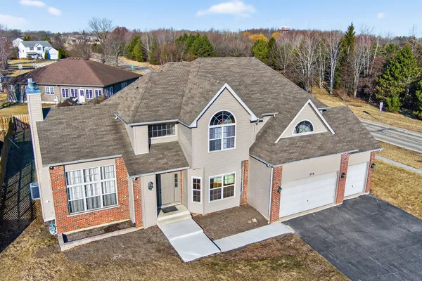 a aerial view of a house next to a yard