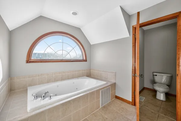 a bathroom with a bathtub and a toilet