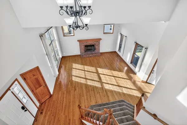 a living room with chairs and a fireplace