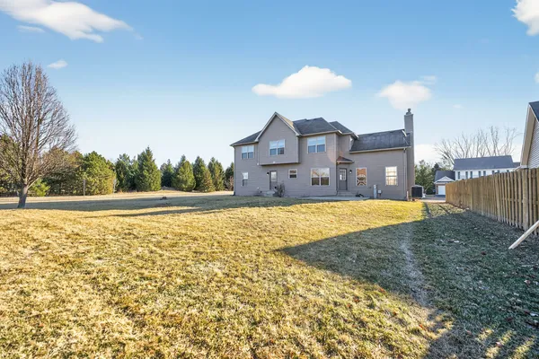 a view of an house with backyard space and a lake view