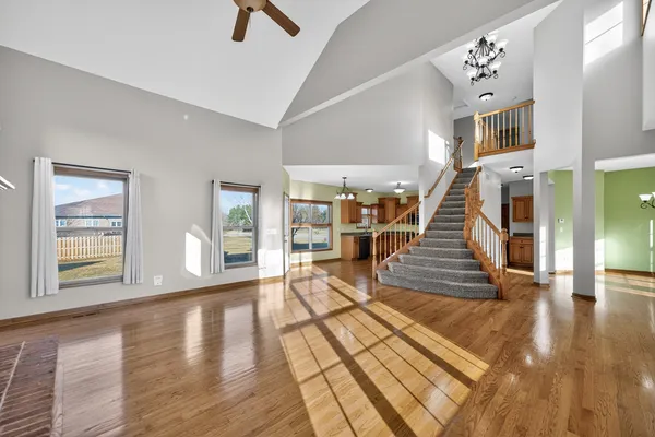 an entryway and livingroom with furniture wooden floor and windows
