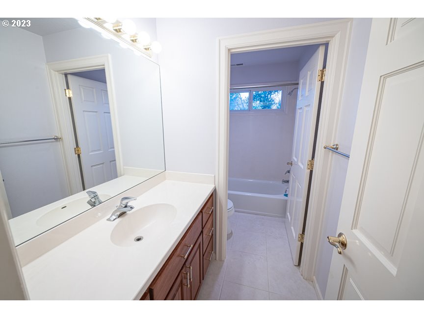 3338 Lakeside Drive Eugene, OR 97401 - Photo 35 of 45 a bathroom with a sink a toilet and a mirror