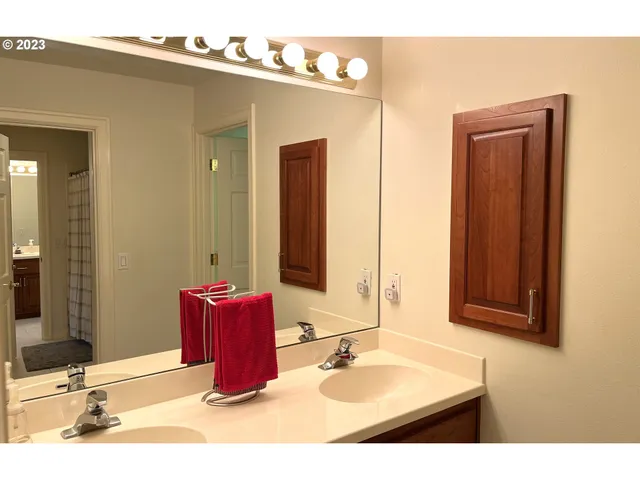 a bathroom with a sink vanity and mirror