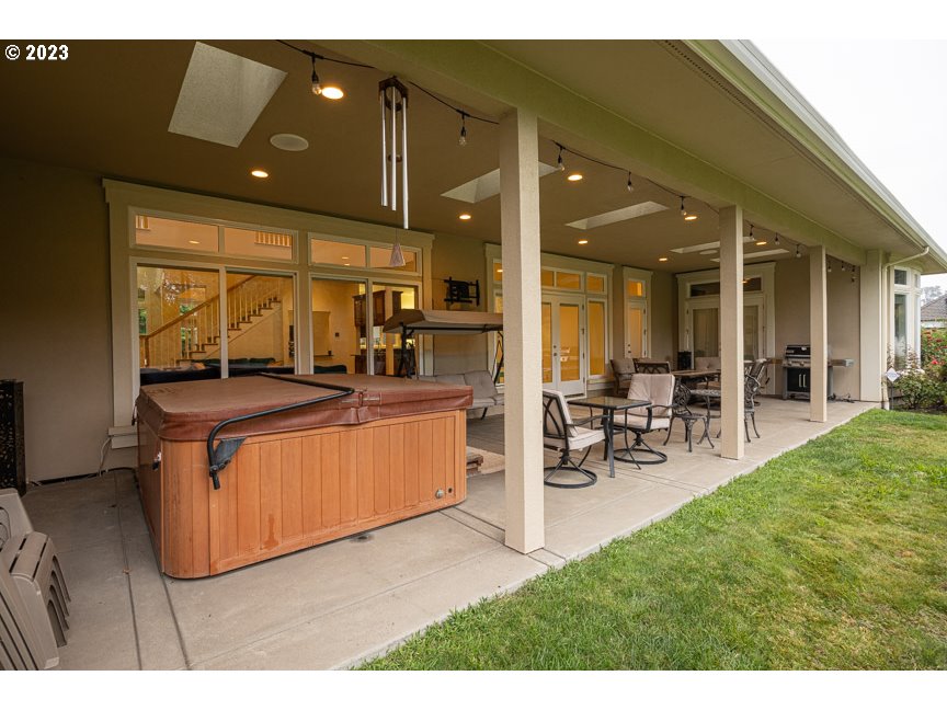 3338 Lakeside Drive Eugene, OR 97401 - Photo 7 of 45 a living room with furniture a flat screen tv and a dining table