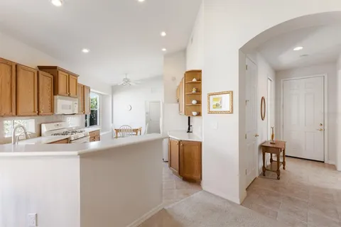 a kitchen with stainless steel appliances granite countertop a sink stove and cabinets