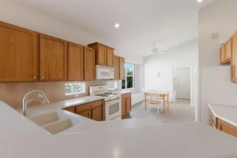 a kitchen with a sink cabinets and window