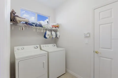 a bedroom with furniture and a chandelier fan