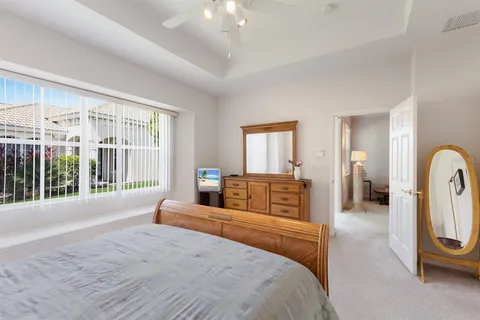 a bathroom with a sink double vanity granite tub shower and a mirror